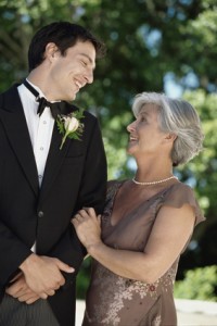 Portrait of a groom posing with his mother at a wedding